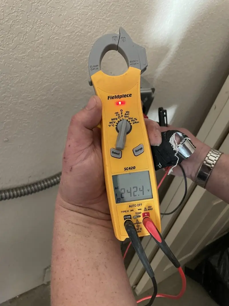 Voltage testing with clamp meter during Ceiling Fan Installation in Locust Grove
